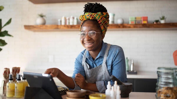 Alumna working the front of a coffee shop